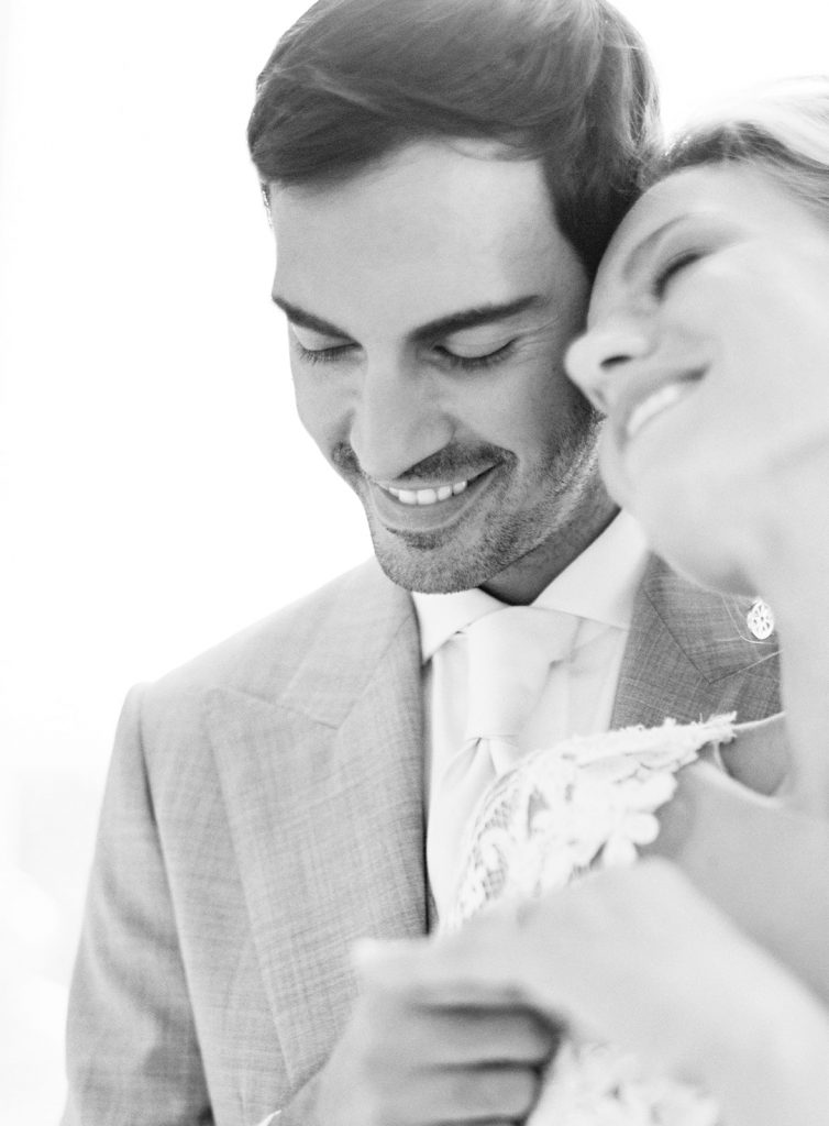 Couple leaning their heads together and laughing. Photographed at destination wedding in Italy by wedding photographers in Charleston Amy Mulder Photography.