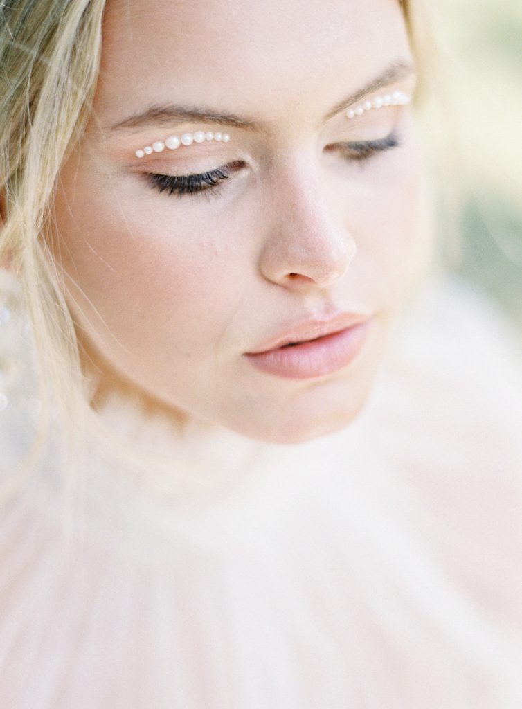 Tiny individual pearls across the tops of the brides eyelids. Photographed by wedding photographers in Charleston Amy Mulder Photography.