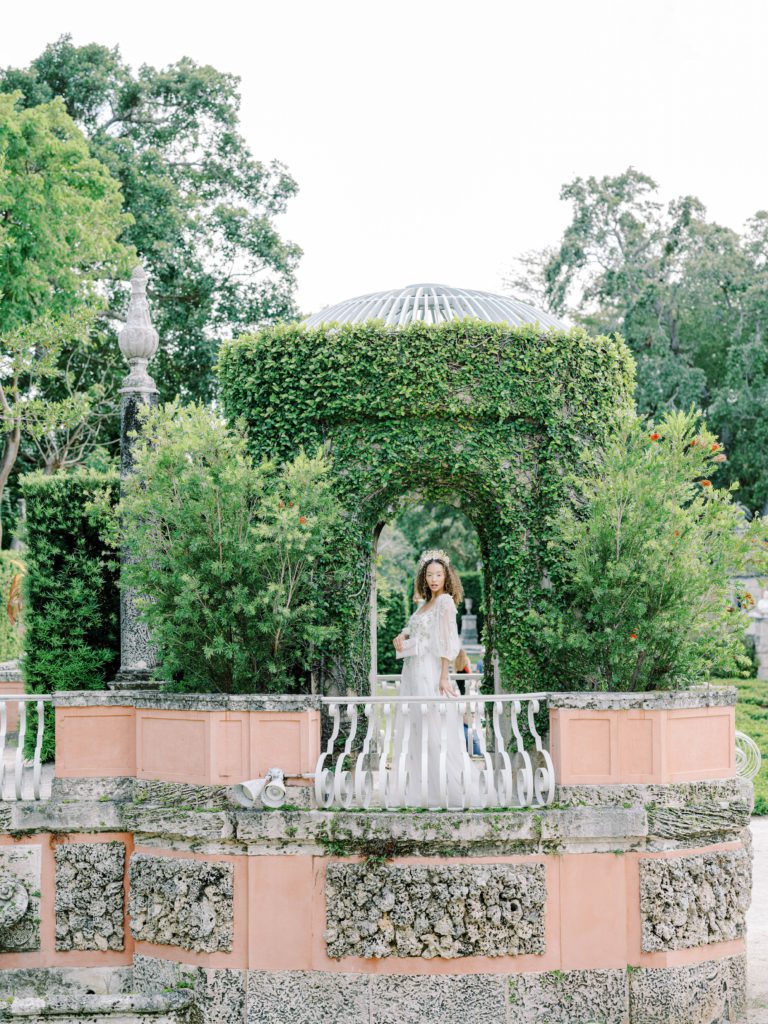 Bride standing in the greenery filled gazebo at Vizcaya museum and gardens. Photographed by Wedding Photographers in Charleston, Amy Mulder Photography.