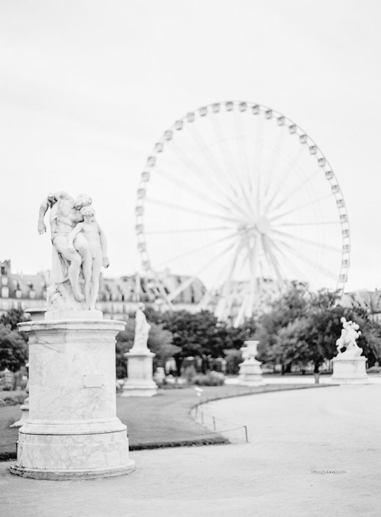 Paris in black and white film photograph, ferris wheel in the summer time. Photographed by Wedding photographers in France, Amy Mulder Photography