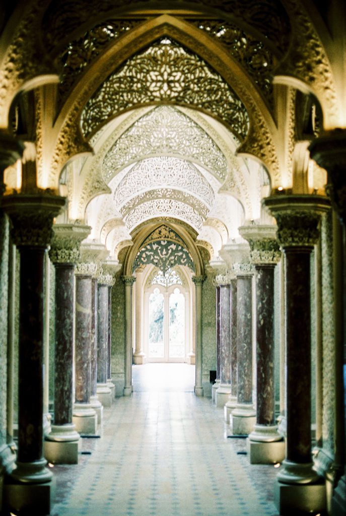 Inside Portugal wedding venue with gothic styled archways and pillars lining down the hallway