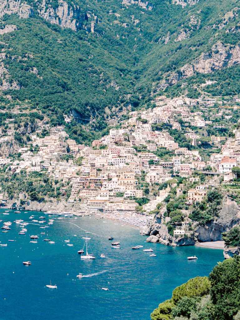 Clear clue waters filled with boats along the Amalfi Coast in Italy