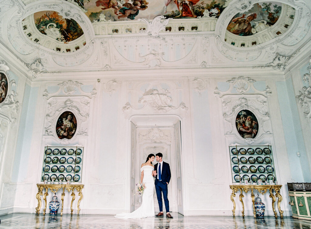Villa Sola Cabiati Wedding with bride in off the shoulder fitted gown and groom in navy blue suit