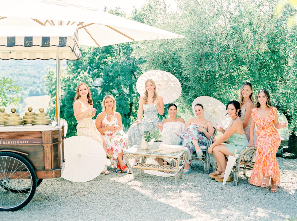 Bridesmaid with parasols at Tuscany Wedding in the olive grove at Villa Montanare near Cortona, Italy photographed by Italy wedding photographer 
