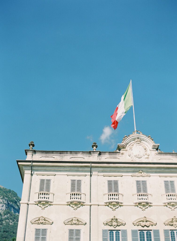 Italy flag atop Villa Sola Cabiati on Lake Como in Italy photographed on film by Lake Como wedding photographer.