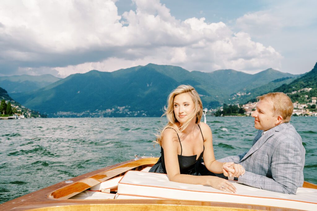 Lake Como Italy engagement session on wooden boat at Passalacqua photographed by Lake Como Photographer