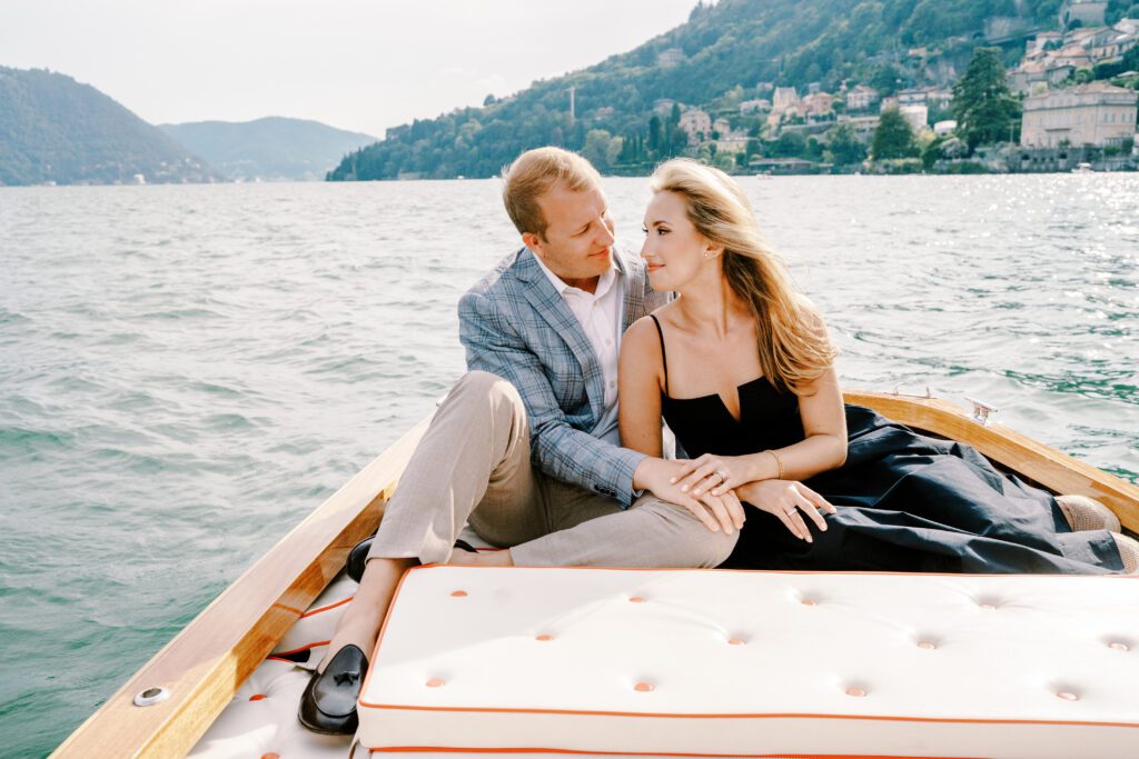 Lake Como Italy engagement session on wooden boat at Passalacqua photographed by Lake Como Photographer