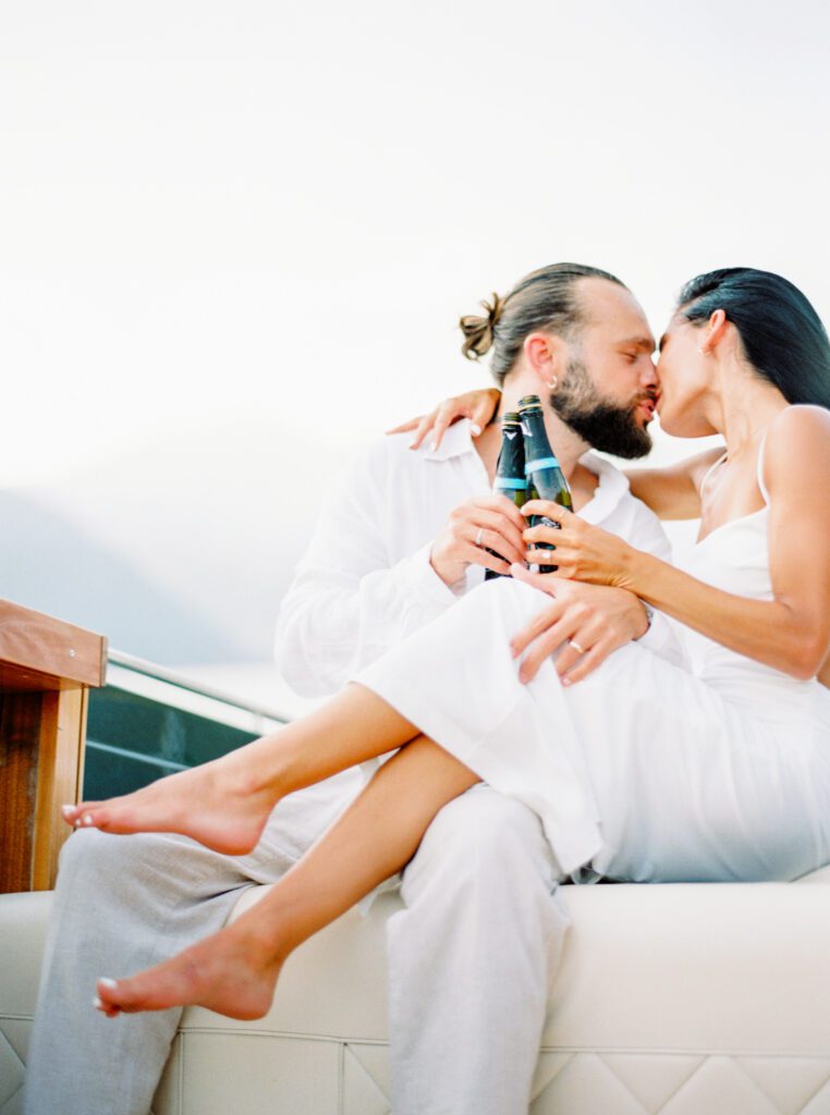 Lake Como Engagement Session of couple in all white on boat photographed by Lake Como photographer