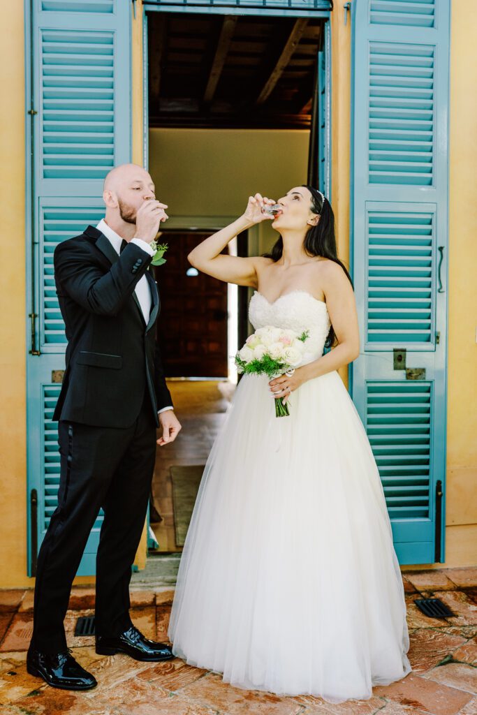 film photograph of bride and groom taking a tequila shot at Lake Como elopement in Italy at Villa la Cassianella photographed by Lake Como photographer