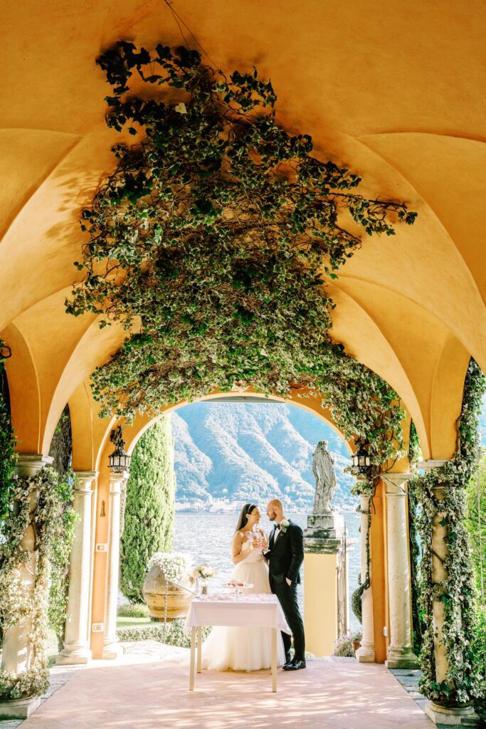 film photograph of bride and groom during their cake cutting at Lake Como elopement in Italy at Villa la Cassianella photographed by Lake Como photographer