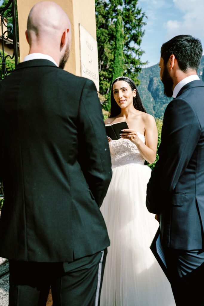 film photograph of bride and groom during their ceremony at Lake Como elopement in Italy at Villa la Cassianella photographed by Lake Como photographer