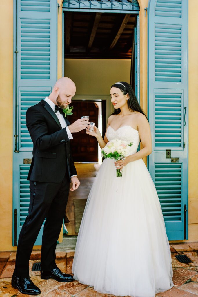 film photograph of bride and groom taking a tequila shot at Lake Como elopement in Italy at Villa la Cassianella photographed by Lake Como photographer