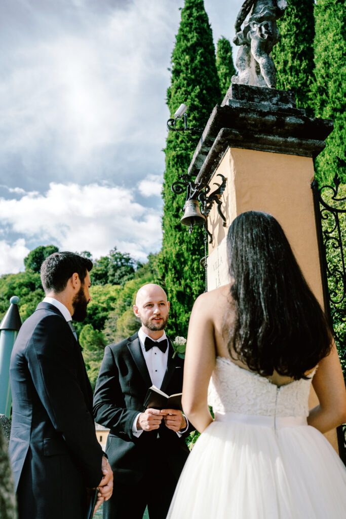 film photograph of bride and groom during their ceremony at Lake Como elopement in Italy at Villa la Cassianella photographed by Lake Como photographer