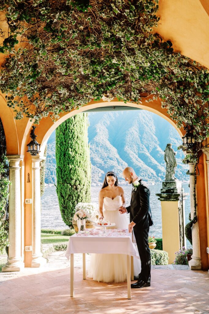 film photograph of bride and groom during their cake cutting at Lake Como elopement in Italy at Villa la Cassianella photographed by Lake Como photographer