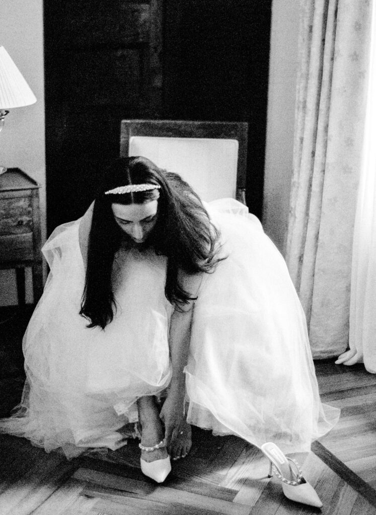 Black and white film photograph of bride getting ready for her Lake Como elopement in Italy at Villa la Cassianella photographed by Lake Como photographer