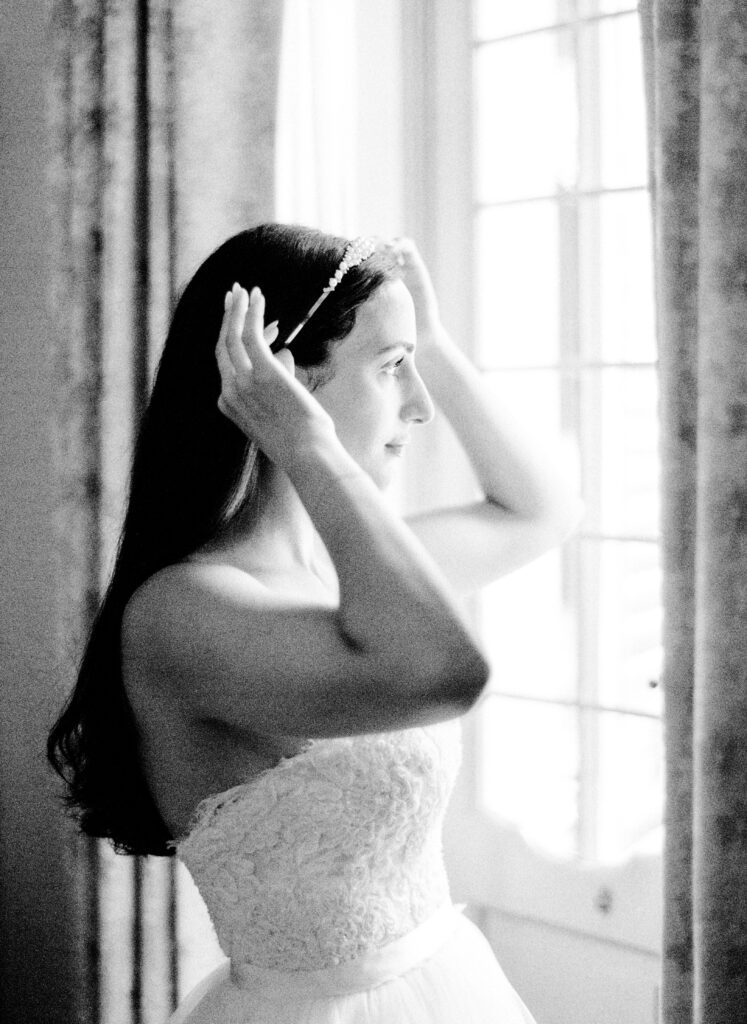 Black and white film photograph of bride getting ready for her Lake Como elopement in Italy at Villa la Cassianella photographed by Lake Como photographer