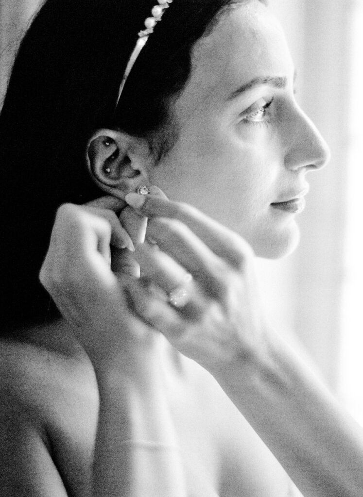 Black and white film photograph of bride getting ready for her Lake Como elopement in Italy at Villa la Cassianella photographed by Lake Como photographer