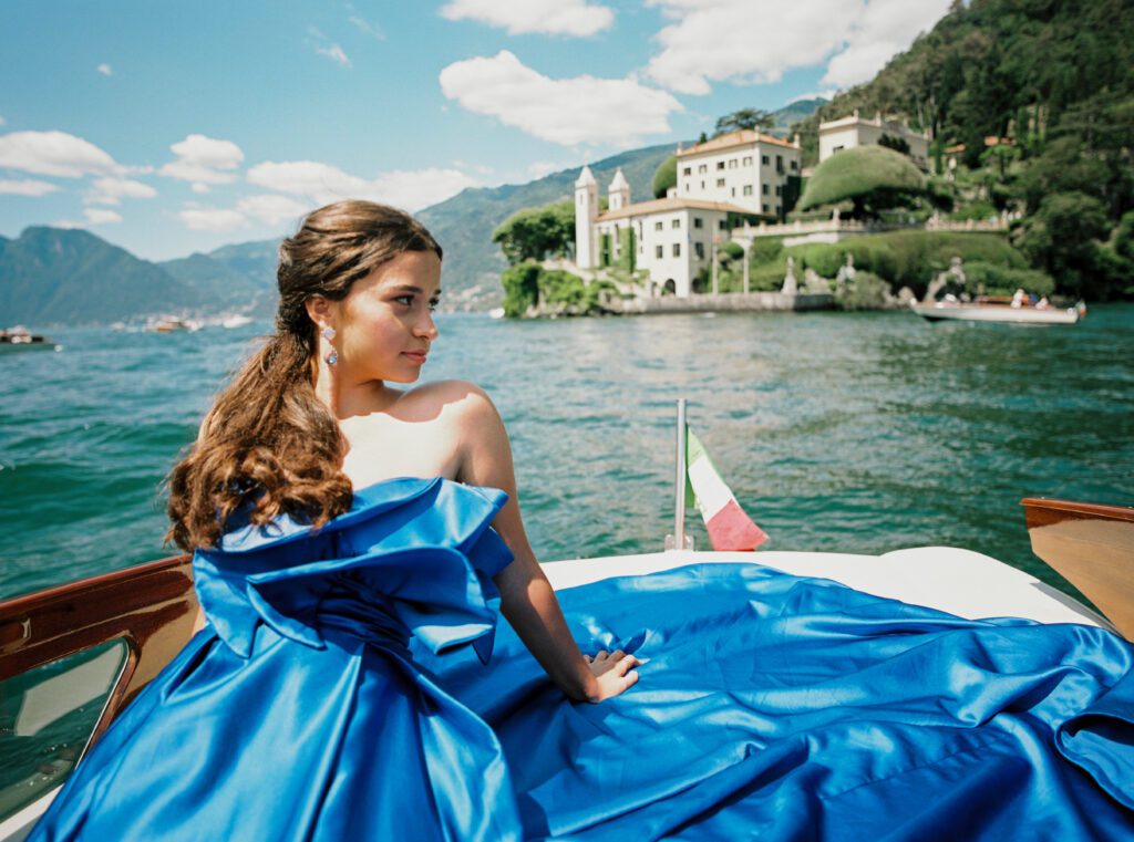 Quinceañera on wooden boat on Lake Como in Italy photographed by Lake Como photographer