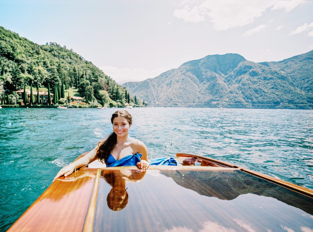 Quinceañera on wooden boat on Lake Como in Italy photographed by Lake Como photographer
